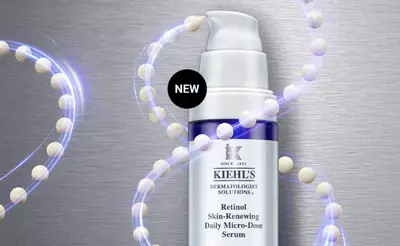 Image of Kiehl's Retinol Skin-Renewing Daily Micro-Dose Serum bottle surrounded by a glowing, abstract representation of molecules, with a "NEW" label in the top corner.