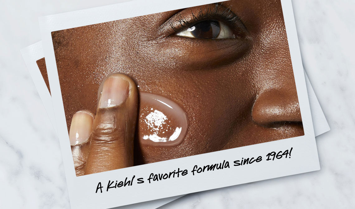 A close-up of a person's face, showing a hand applying a clear skincare product to their cheek, with text stating "A Kiehl's favorite formula since 1964!"