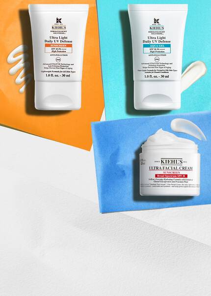 Två Kiehl's solskyddsprodukter bredvid en burk Ultra Facial Cream med SPF mot ljusa bakgrunder, som framhaver UV-skyddande egenskaper.