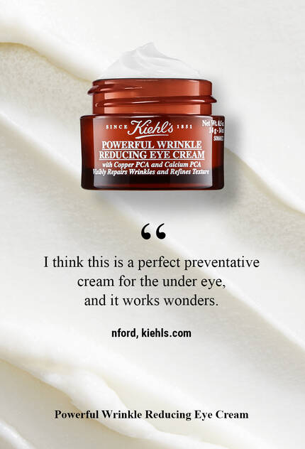 A jar of Kiehl's Powerful Wrinkle Reducing Eye Cream placed on a creamy background, accompanied by a quote about its effectiveness and a website link.