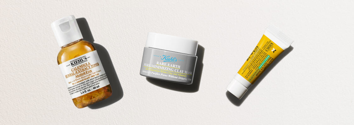 Tre hudvårdsprodukter från Kiehl's mot en ljus bakgrund: Calendula-toner, Rare Earth-lermask och en liten gul tub.