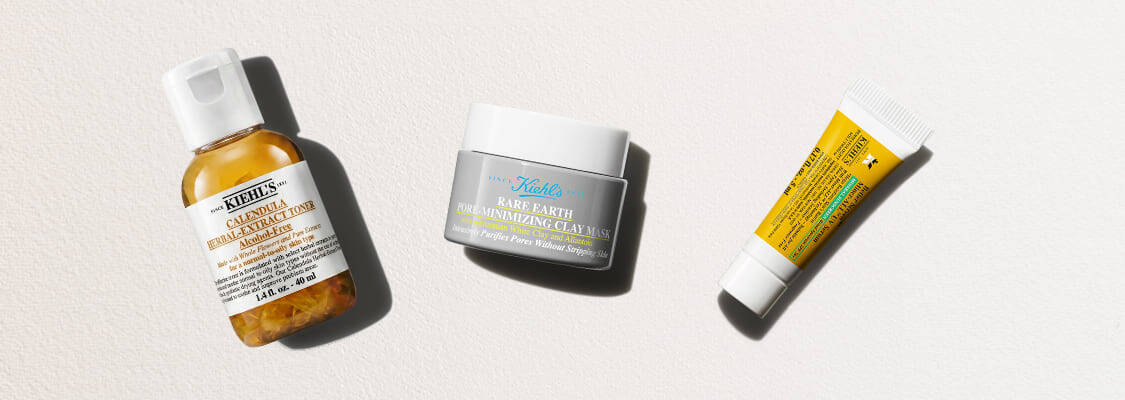 Tre hudvårdsprodukter från Kiehl's mot en ljus bakgrund: Calendula-toner, Rare Earth-lermask och en liten gul tub.