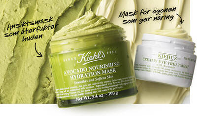 Close-up of two skincare products: a green jar labeled "Avocado Nourishing Hydration Mask" for smoothing and hydrating the skin, and a white jar labeled "Creamy Eye Treatment" for nourishing the eye area, set against a textured green backdrop.