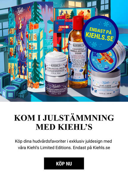 A festive display featuring Kiehl's limited edition holiday skincare products, including lotions and creams, set against a wintry backdrop with snowflakes and festive decorations.