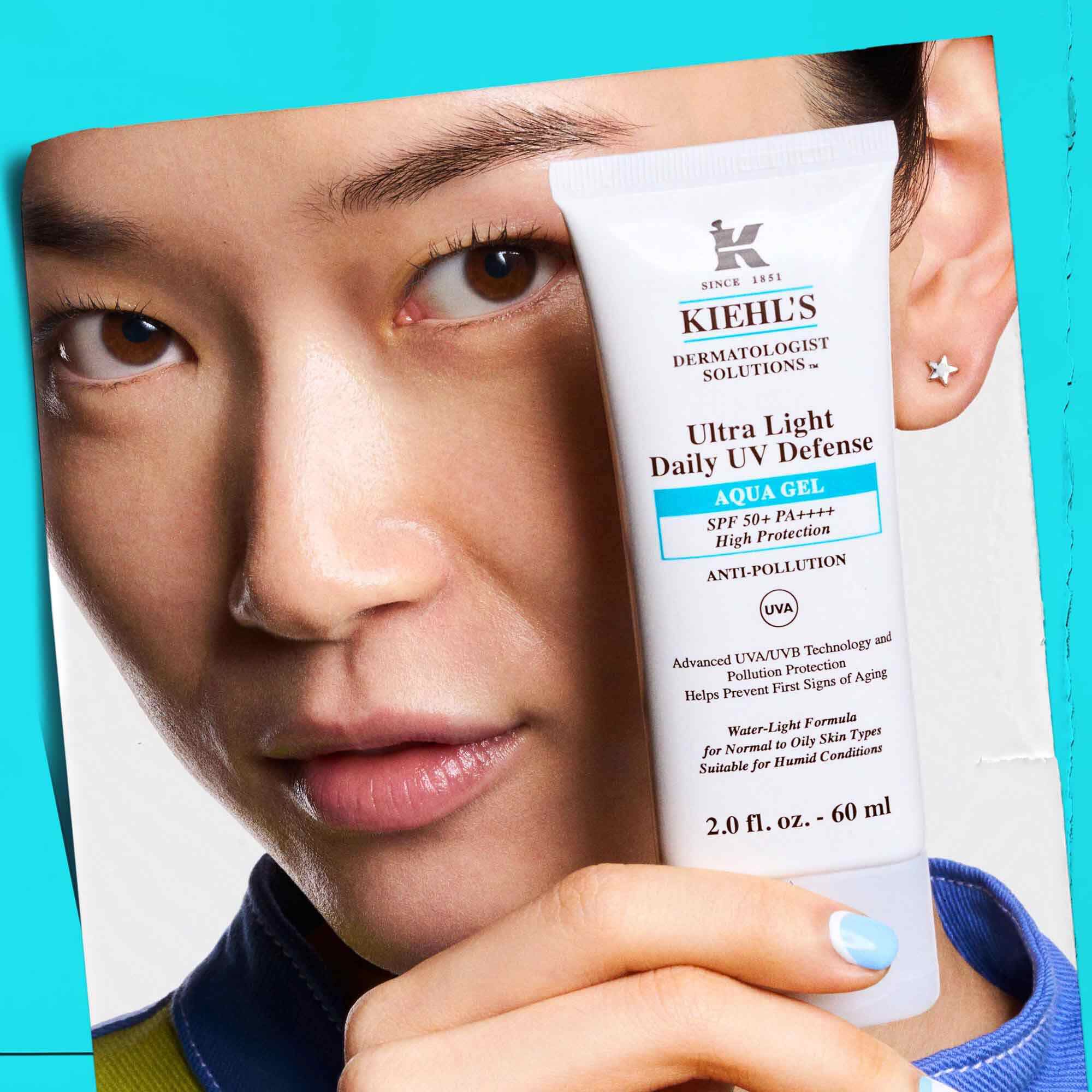 En modell som håller en tub Ultra Light Daily UV Defense Aqua Gel, vilket visar dess barbarhet och anvandarvanlighet.