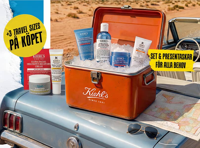 Set Kiehl's Oil-Free Essentials dans une glacière vintage sur une voiture bleue, entouré de glace et d'une carte.